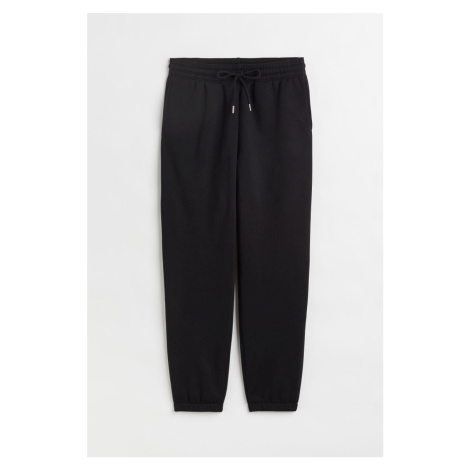 H & M - Teplákové kalhoty z bavlněné směsi - černá H&M