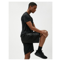 Koton Lace-Up Sports Shorts with Pocket Details with a Slogan Print.