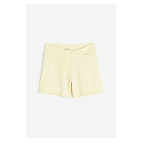 H & M - Sportovní šortky hotpants z materiálu SoftMove™ - žlutá H&M