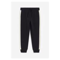 H & M - Kalhoty jogger's potiskem - černá