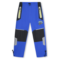 Chlapecké šusťákové kalhoty - KUGO SK7736, modrá Barva: Modrá