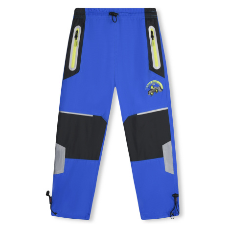 Chlapecké šusťákové kalhoty - KUGO SK7736, modrá Barva: Modrá