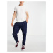 ASOS DESIGN relaxed tapered pleated jeans in dark blue