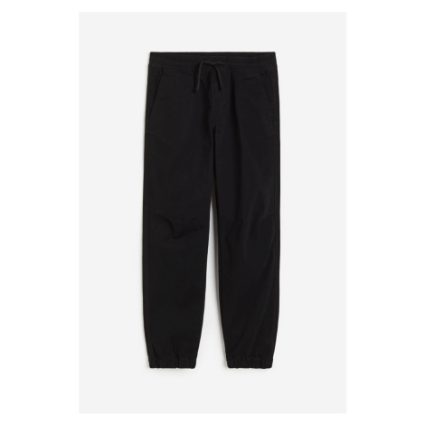 H & M - Bavlněné kalhoty jogger - černá H&M