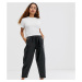 ASOS DESIGN Petite tapered leather look trousers-Black