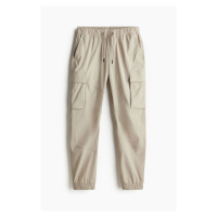 H & M - Nylonové kalhoty cargo jogger Slim Fit - béžová