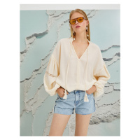 Koton Şahika Ercümen X - Tassel Detailed V-Neck Blouse with Balloon Sleeves.