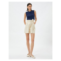 Koton Silky-textured shorts with a belt and pockets.