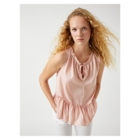 Koton Sleeveless blouse with fastening detail, satin look.