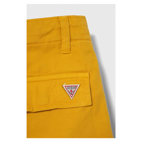 Dětské bavlněné kalhoty Guess žlutá barva, hladké